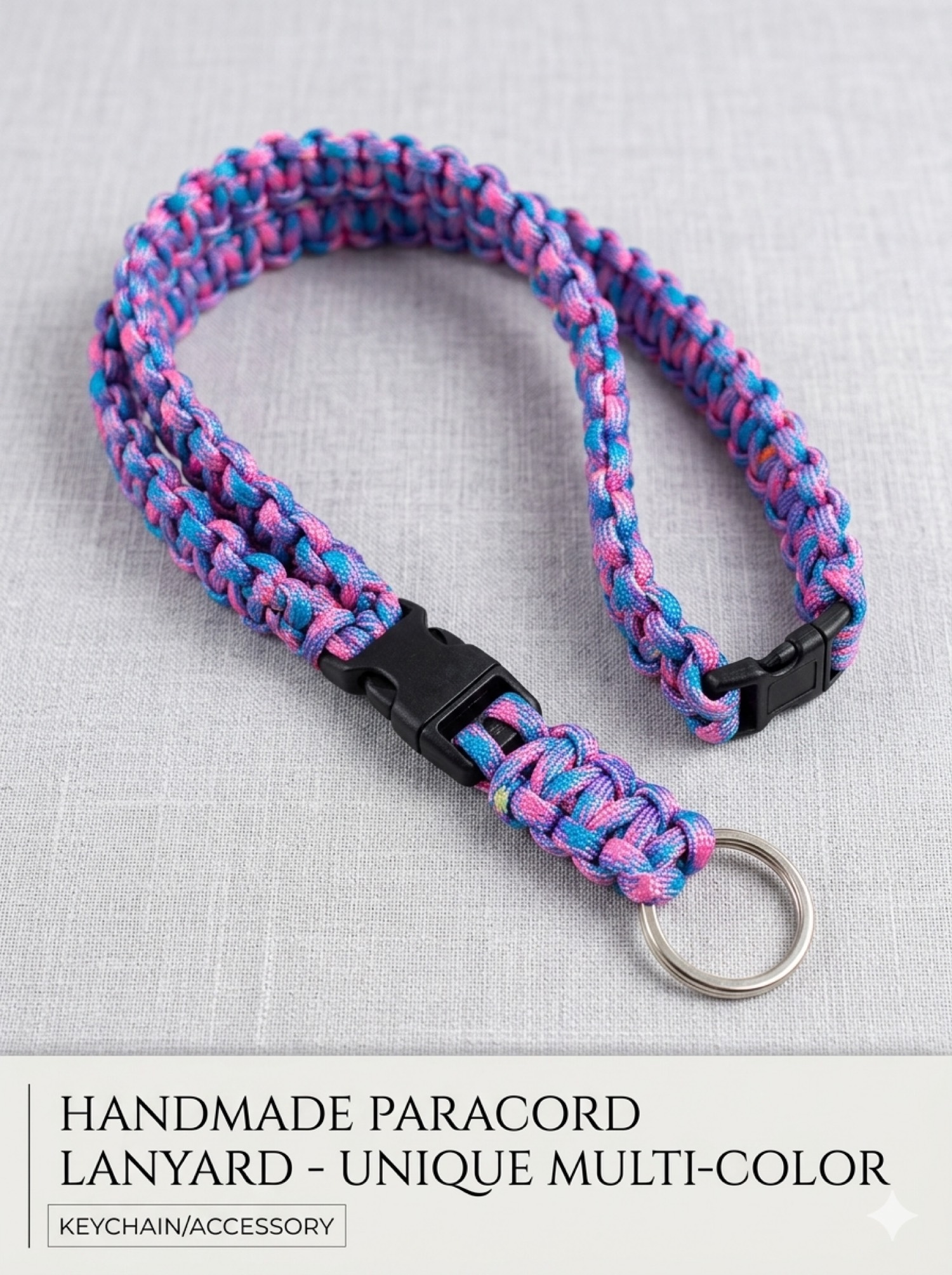 Pink blue and purple paracord lanyard with a black buckle and metal ring